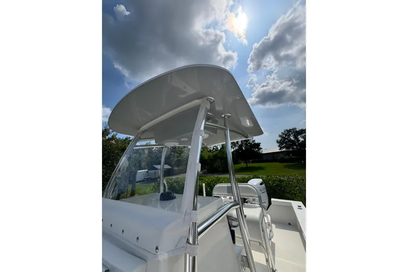 Slide: The Image of 2022 Rambo 27 boat with sleek design under a partly cloudy sky. - 6