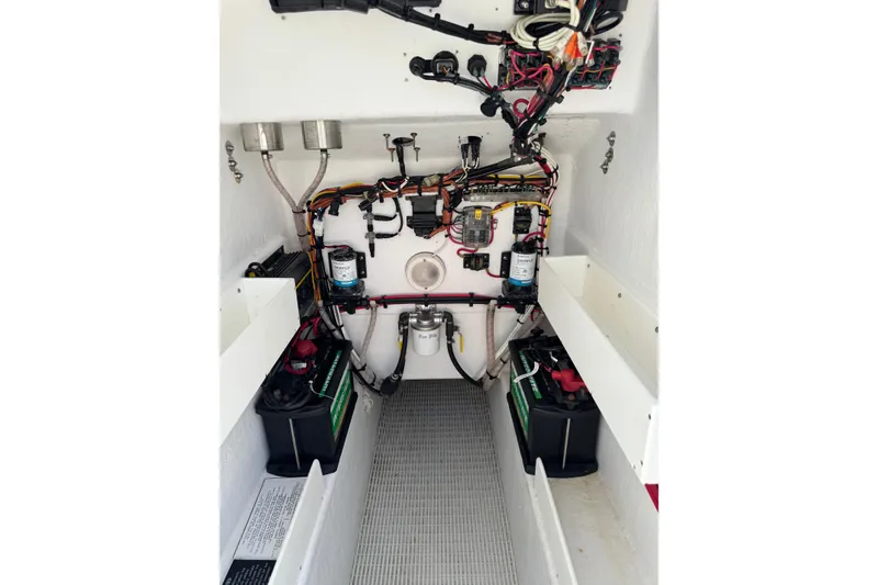 Slide: The Image of Electrical system inside a 2022 Rambo 27 boat, featuring batteries and wiring. - 9