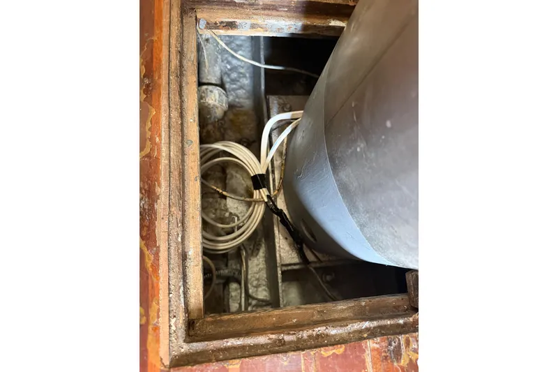 Slide: The Image of 1977 Morgan Out Island 51 sailboat interior showing wiring and structural details. - 52