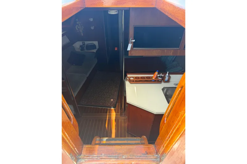 Slide: The Image of Interior view of 1977 Morgan Out Island 51 sailboat, featuring cozy cabin and kitchenette. - 28