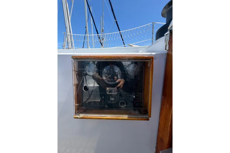 Slide: The Image of 1977 Morgan Out Island 51 yacht dashboard with gauges and controls under glass. - 26