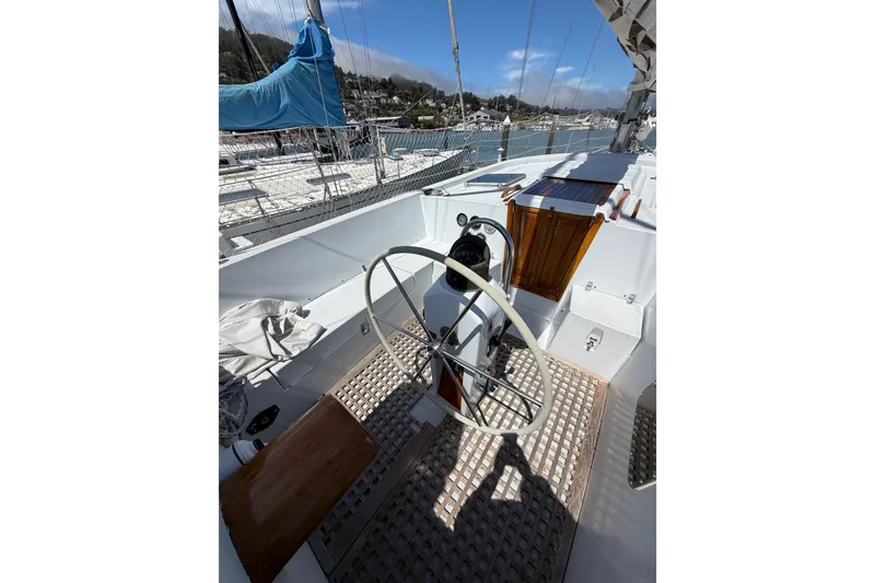 Slide: The Image of 1977 Morgan Out Island 51 sailboat cockpit with steering wheel and wooden accents. - 25
