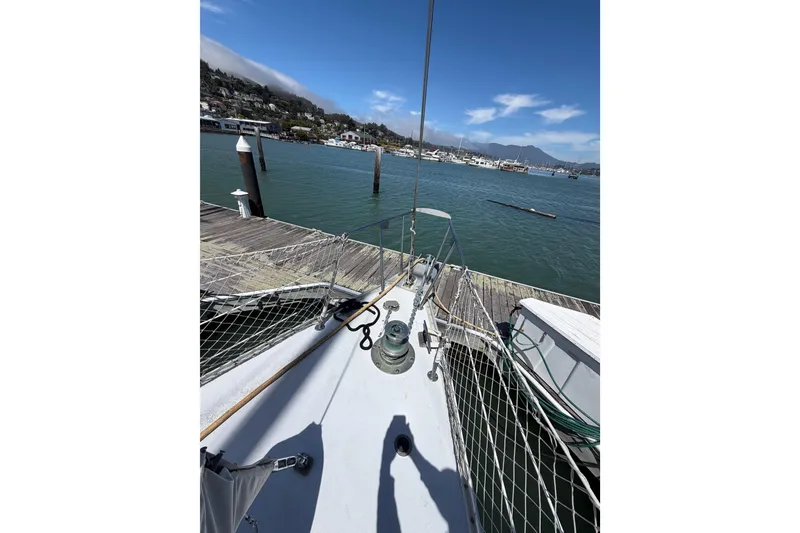 Slide: The Image of Bow view of 1977 Morgan Out Island 51 sailboat docked at a marina. - 21