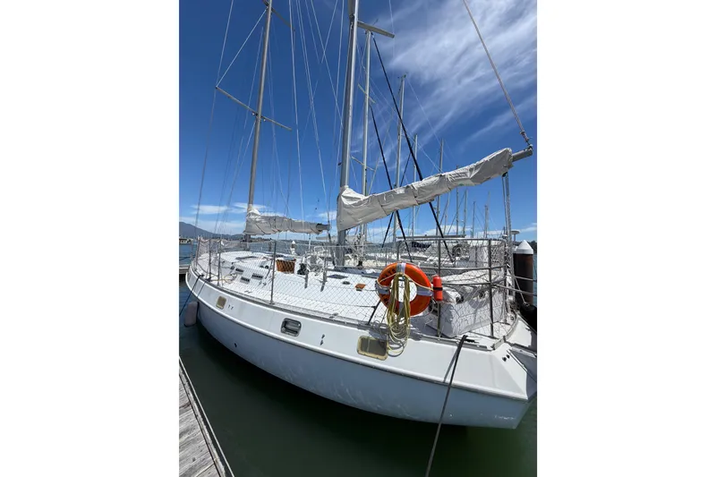 Slide: The Image of 1977 Morgan Out Island 51 sailboat docked under clear blue sky. - 59