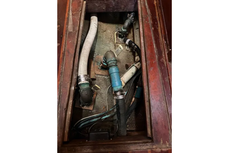Slide: The Image of 1977 Morgan Out Island 51 boat plumbing system with hoses and fittings. - 53