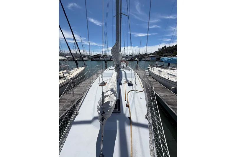 Slide: The Image of 1977 Morgan Out Island 51 sailboat docked at a marina under a clear blue sky. - 20