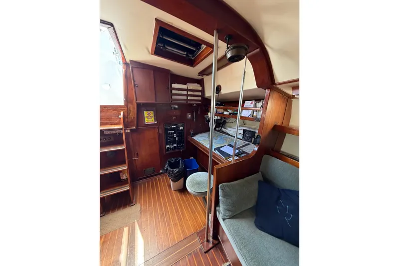 Slide: The Image of Interior of 1977 Morgan Out Island 51 sailboat with wooden cabinetry and navigation station. - 51