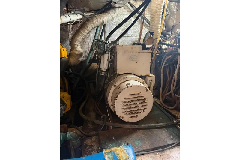 Slide: The Image of Engine room of a 1977 Morgan Out Island 51 sailboat, featuring mechanical components. - 55