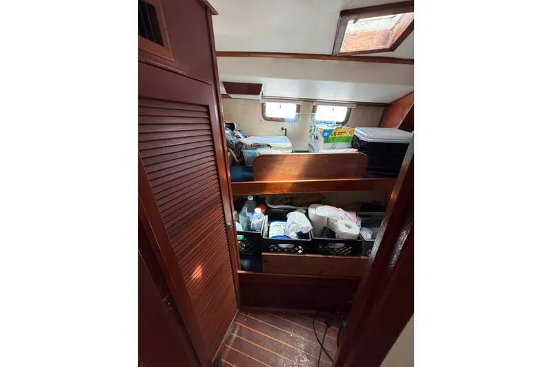 Slide: The Image of Interior of 1977 Morgan Out Island 51 sailboat with storage and supplies. - 46