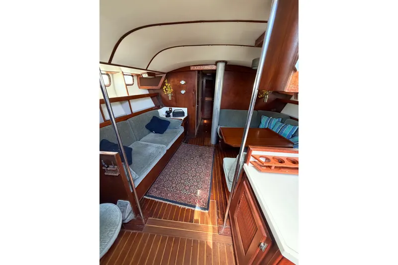 Slide: The Image of Interior of 1977 Morgan Out Island 51 yacht with cozy seating and wooden finishes. - 29