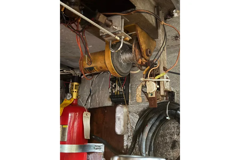Slide: The Image of Engine room of a 1977 Morgan Out Island 51 sailboat with mechanical components. - 58