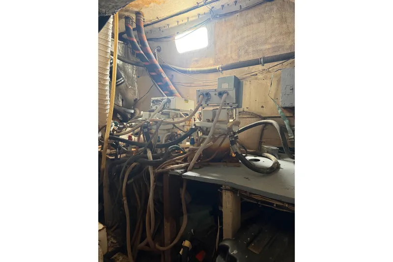 Slide: The Image of Engine room of a 1977 Morgan Out Island 51 sailboat with complex piping system. - 57