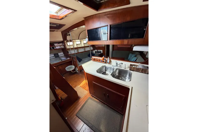 Slide: The Image of Interior of 1977 Morgan Out Island 51 yacht with wooden cabinetry and dual sink. - 40