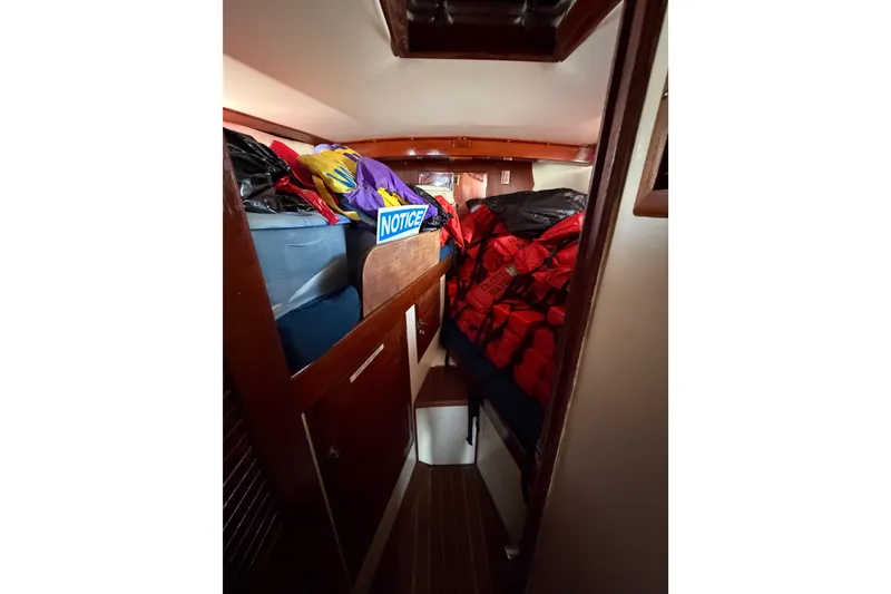Slide: The Image of 1977 Morgan Out Island 51 cabin interior with storage and life jackets. - 48