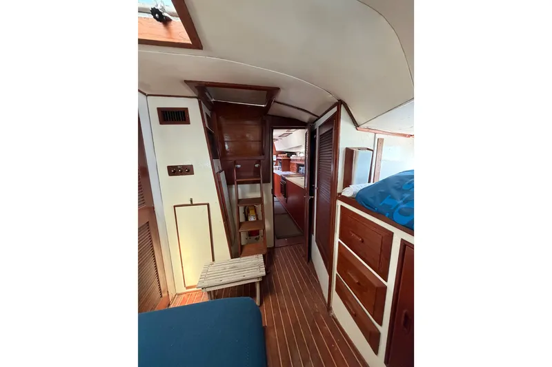 Slide: The Image of 1977 Morgan Out Island 51 yacht interior with wooden cabinetry and cozy living space. - 33