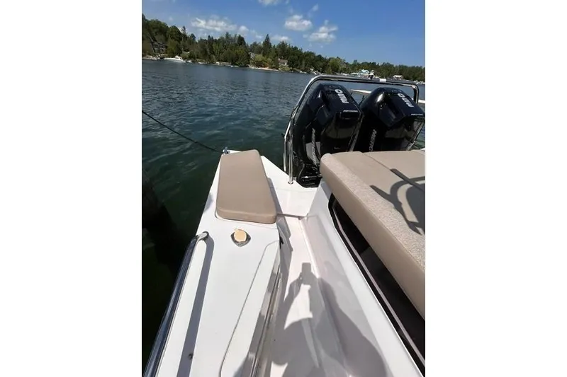 Slide: The Image of 2024 Axopar 37 XC Cross Cabin boat with dual engines on a sunny lake. - 17