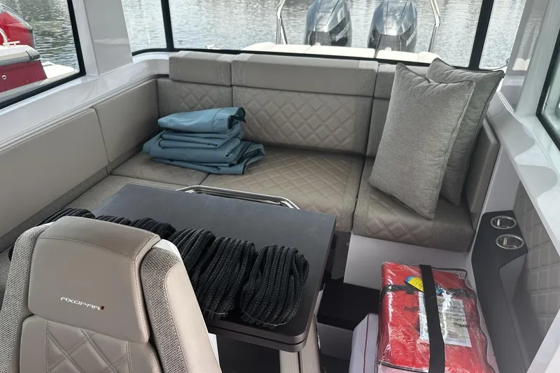 Slide: The Image of Interior of 2024 Axopar 37 XC Cross Cabin with seating, table, and accessories. - 13