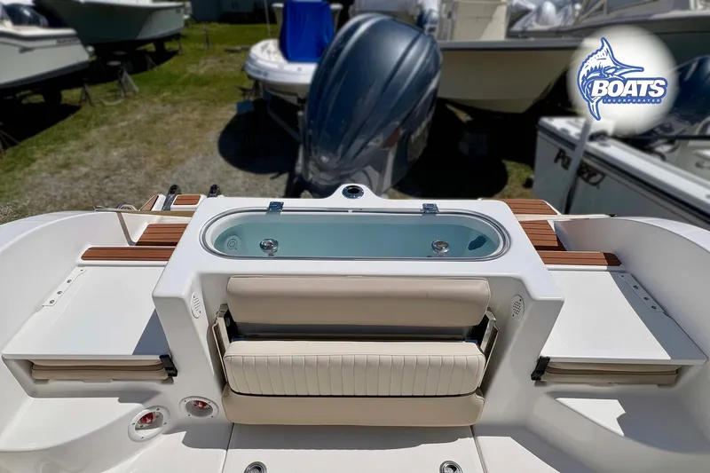 Slide: The Image of 2015 Sea Fox 266 Commander boat deck with seating and storage compartments. - 10