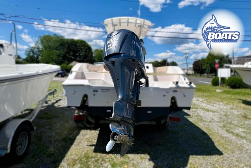 Slide: The Image of 2015 Sea Fox 266 Commander boat with Yamaha 300 V6 engine, displayed outdoors. - 12