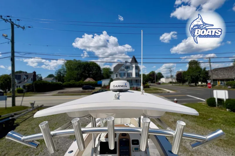 Slide: The Image of 2015 Sea Fox 266 Commander boat with Garmin equipment, parked near a residential area under a blue sky. - 5