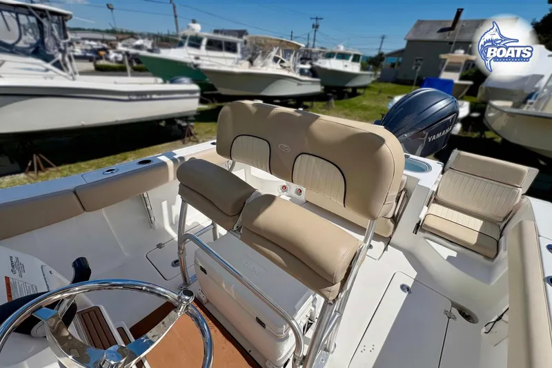 Slide: The Image of 2015 Sea Fox 266 Commander boat interior with beige seating and Yamaha engine. - 7