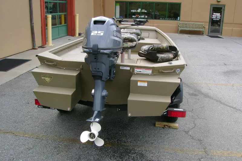 Slide: The Image of 2023 G3 1652 DK boat with Yamaha 25 outboard motor, parked outdoors. - 3