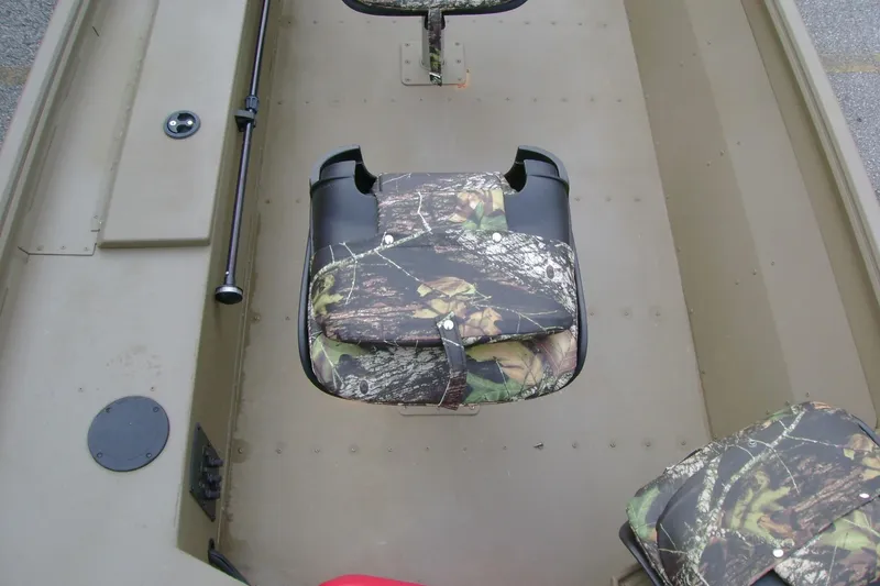 Slide: The Image of 2023 G3 1652 DK boat interior with camouflage seating and storage compartments. - 7