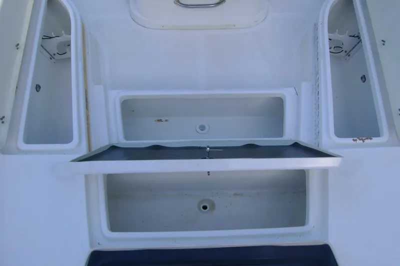 Slide: The Image of 2022 NauticStar 227 XTS boat storage compartments and seating area. - 14