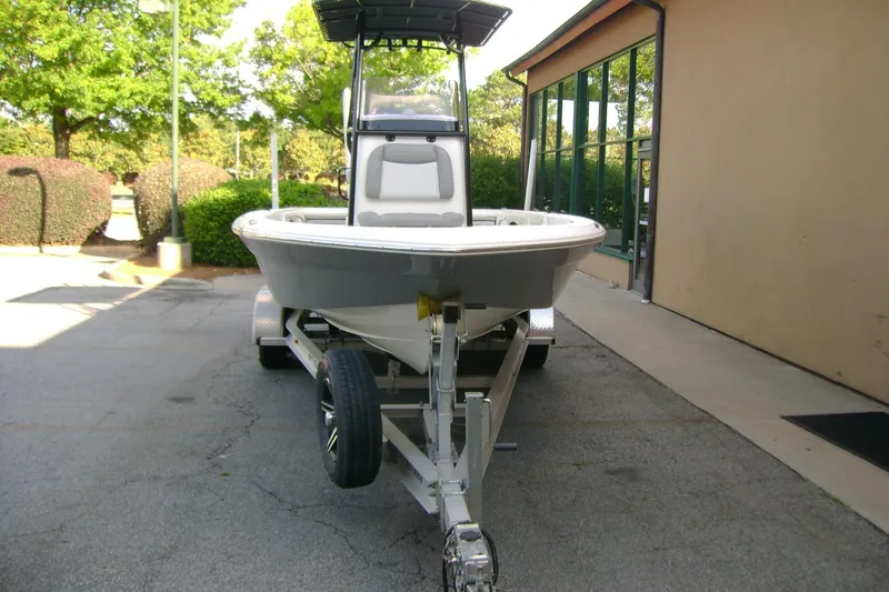 Slide: The Image of 2022 NauticStar 227 XTS boat on trailer, parked outdoors near building. - 3