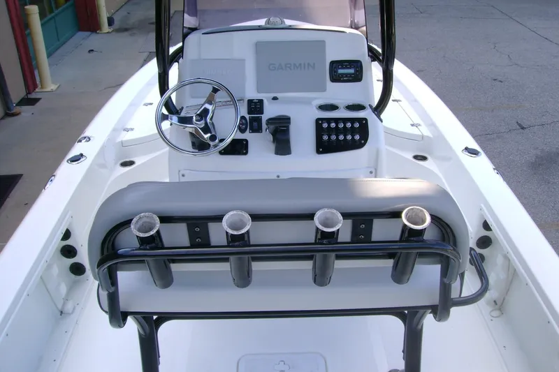 Slide: The Image of 2022 NauticStar 227 XTS boat console with steering wheel and rod holders. - 5