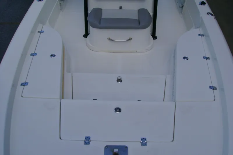 Slide: The Image of 2022 NauticStar 227 XTS boat interior with storage compartments and seating. - 9
