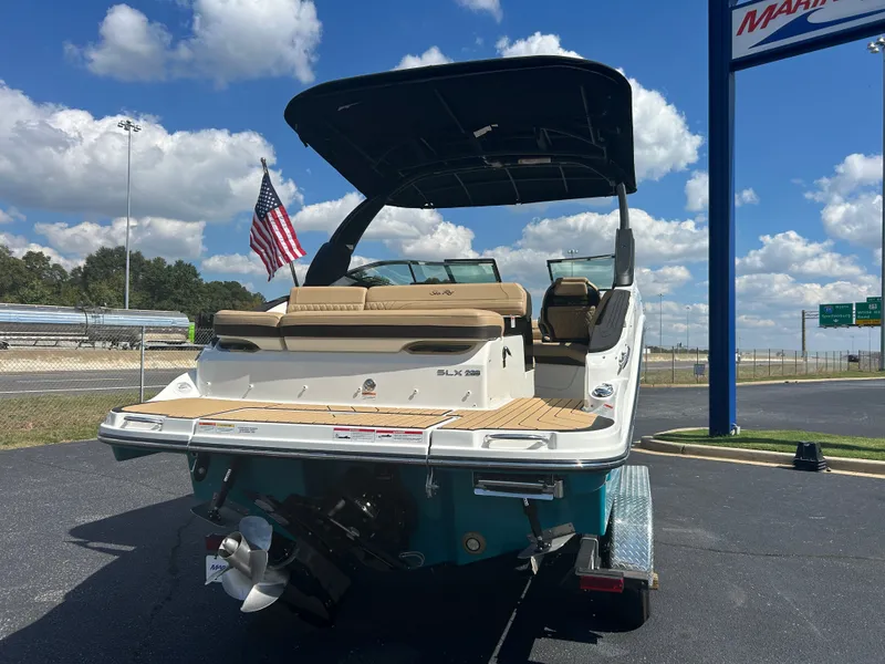 Slide: The Image of The image shows a 2027 Sea Ray SLX 260 boat with an American flag in the background. - 7