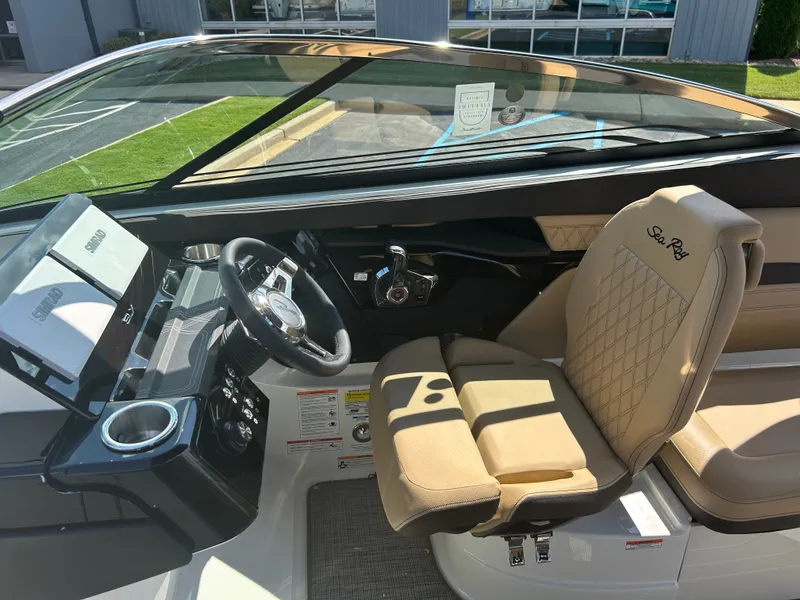 Slide: The Image of The image shows the cockpit of a 2027 Sea Ray SLX 260 with a beige leather seat. - 21
