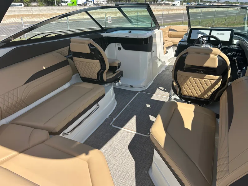 Slide: The Image of The image shows the interior of a 2027 Sea Ray SLX 260 boat with elegant beige seating. - 12
