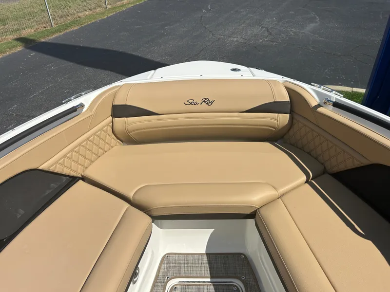 Slide: The Image of The image shows the bow area of a Sea Ray SLX 260 with beige upholstery and quilted details. - 32