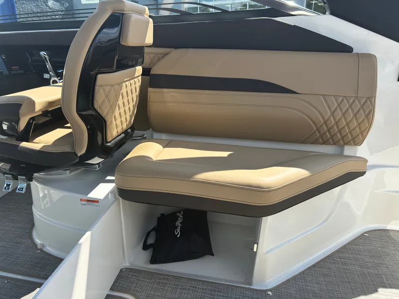 Slide: The Image of The 2027 Sea Ray SLX 260 features a luxurious beige upholstered seat with elegant stitching. - 18