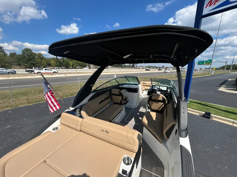 Slide: The Image of The image shows a 2027 Sea Ray SLX 260 boat with beige seating and a black sunshade. - 11