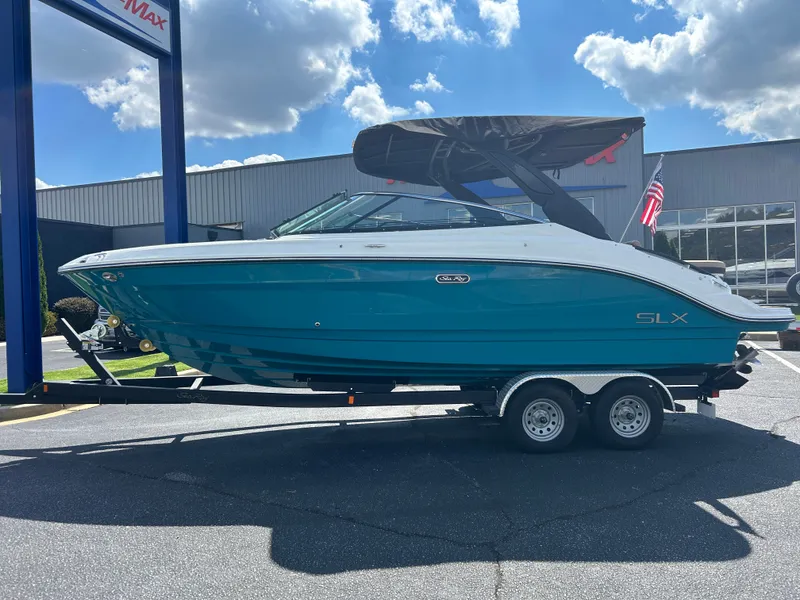 Slide: The Image of A 2027 Sea Ray SLX 260 on a trailer under a blue sky. - 4