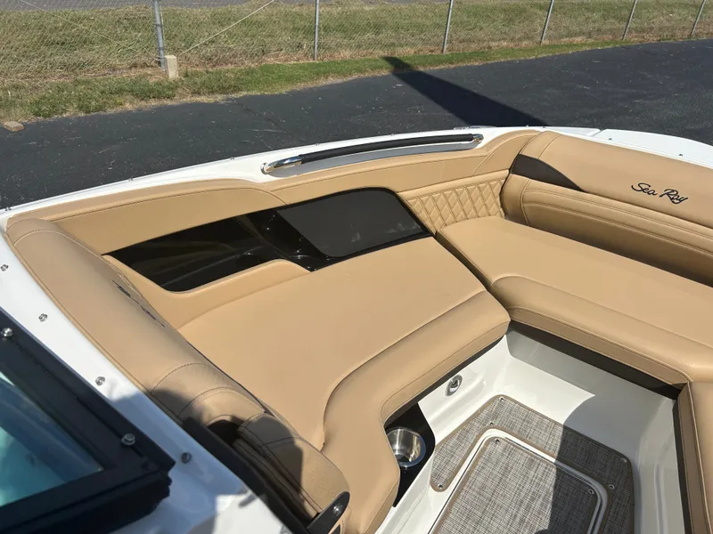 Slide: The Image of The image shows the cockpit of a Sea Ray SLX 260 with beige upholstery and sleek details. - 33