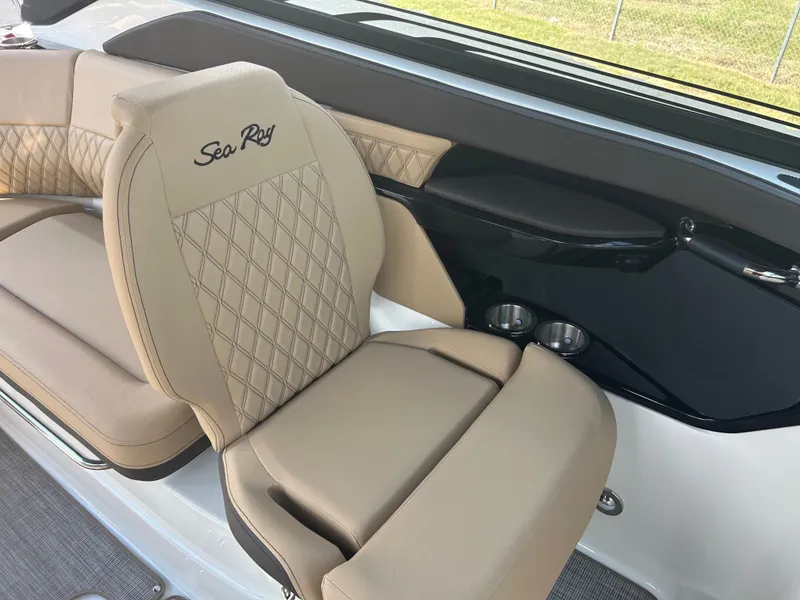 Slide: The Image of The 2027 Sea Ray SLX 260 features luxurious beige upholstery with a quilted pattern and cup holders. - 25