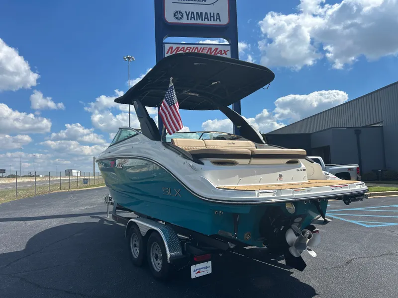 Slide: The Image of The image shows a Sea Ray SLX 260 boat on a trailer under a blue sky. - 5