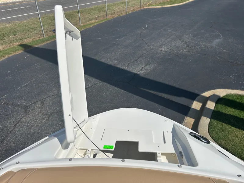 Slide: The Image of The image shows the bow of a 2027 Sea Ray SLX 260 boat with an anchor compartment. - 34