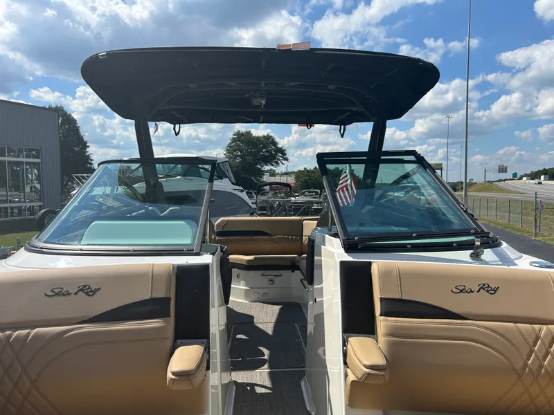 Slide: The Image of The image shows a 2027 Sea Ray SLX 260 boat with beige seats and a black canopy. - 37