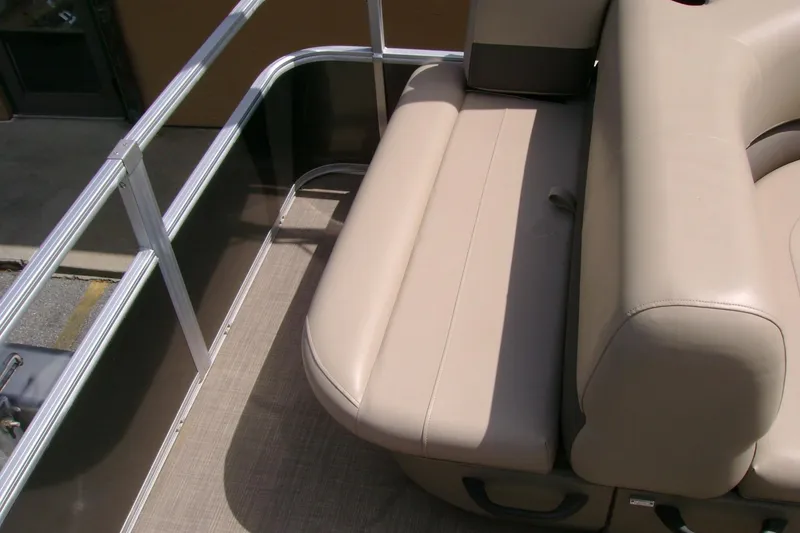 Slide: The Image of 2025 Sun Tracker Party Barge 18 DLX beige seating area with metal railing. - 10