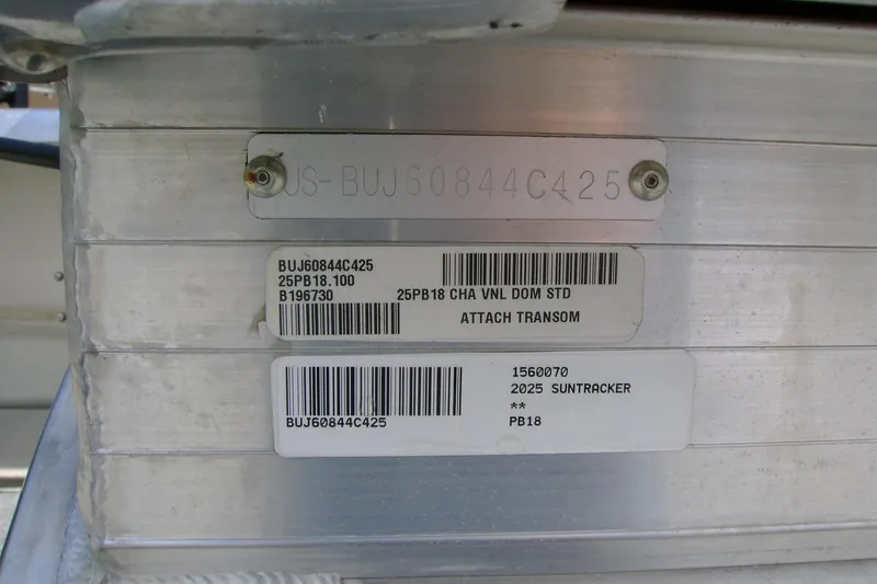 Slide: The Image of 2025 Sun Tracker Party Barge 18 DLX identification labels on aluminum surface. - 14