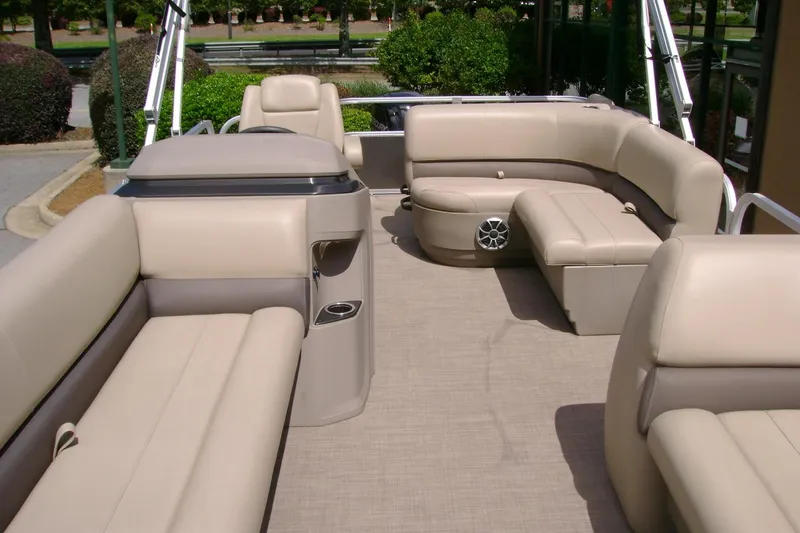 Slide: The Image of 2025 Sun Tracker Party Barge 18 DLX interior with beige seating and spacious layout. - 7