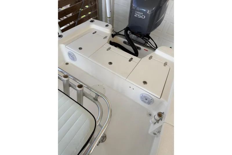 Slide: The Image of 2006 BlackJack 224 boat interior with Yamaha 250 engine, featuring storage compartments and seating. - 12