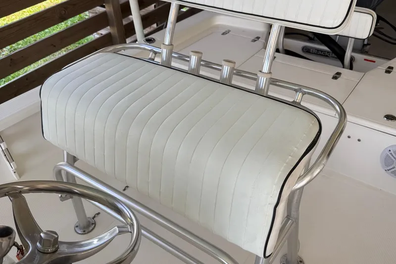 Slide: The Image of White cushioned seat on a 2006 BlackJack 224 boat, featuring sleek metal frame. - 15