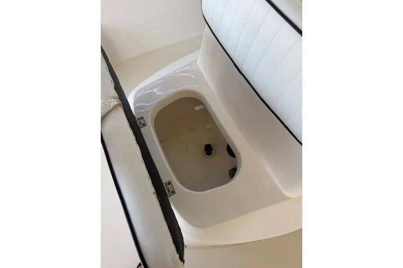 Slide: The Image of Open storage compartment in 2006 BlackJack 224 boat interior. - 22