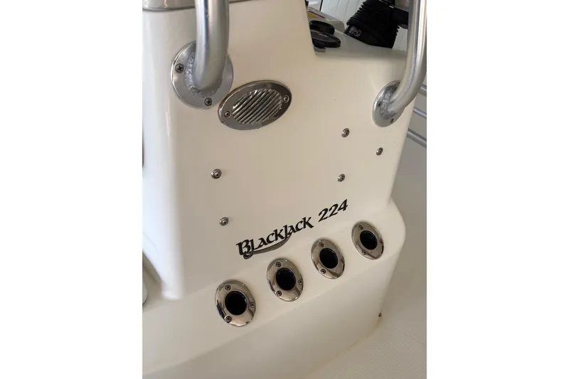 Slide: The Image of 2006 BlackJack 224 boat console with rod holders and sleek design. - 23